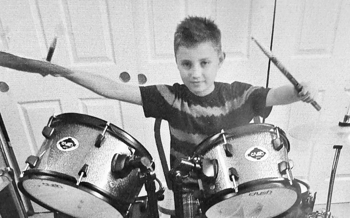 Jack as a kid behind his first drum kit